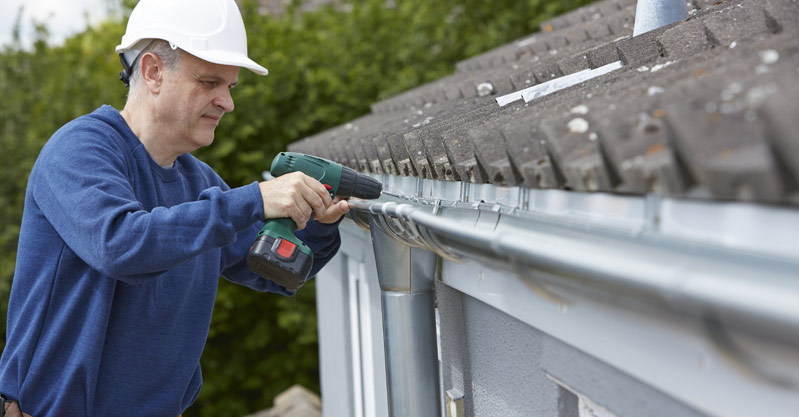 Workman Replacing Guttering On